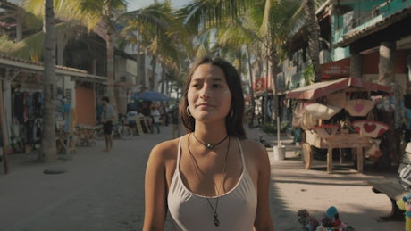 Girl walking on a beach street
