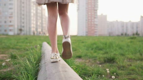 Girl walking on a concrete slab