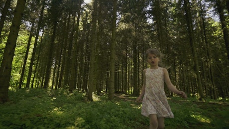 Girl walking through a forest