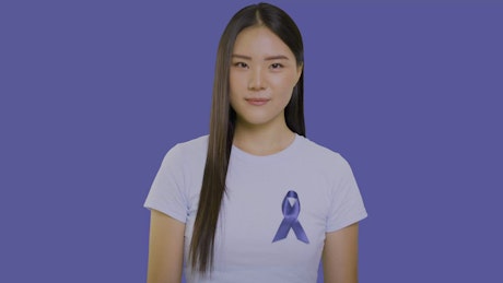 Girl with a ribbon of solidarity with stomach cancer.