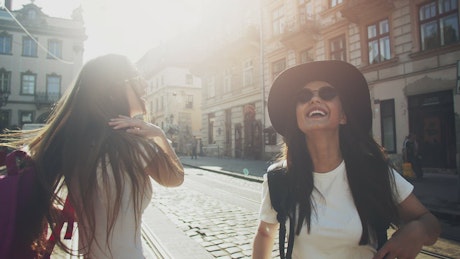 Girlfriends walk through European city amiring sights