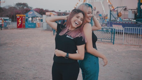 Girls smiling at the amusement park