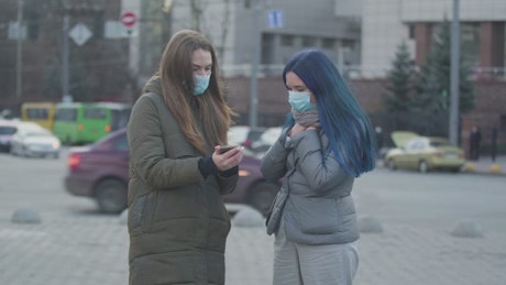 Girls with masks informing about the coronavirus