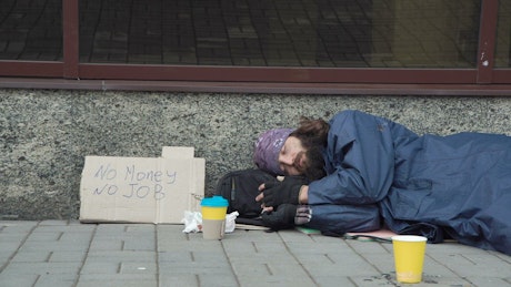 Giving money to homeless man.