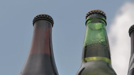 Glass bottles of beer on a sunny day.