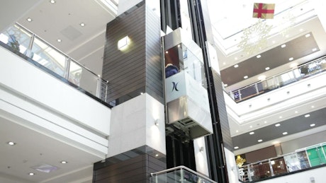 Glass elevator inside a shopping centre