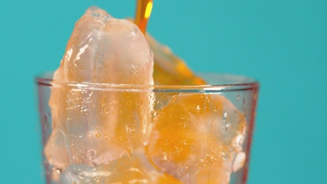 Glass with ice with orange soda.