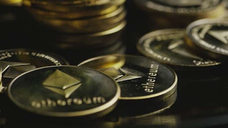 Golden Ethereum coins rotating.
