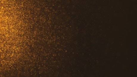 Golden particles background.