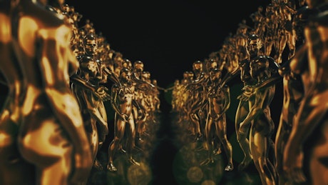 Golden sculptures of human figures, loop video
