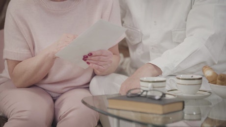 Grandparents reading a letter from their family.