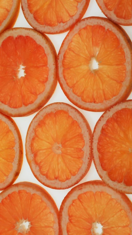 Grapefruit slices over a white background.