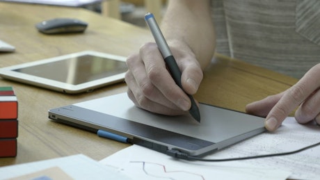 Graphic designer working with a graphic tablet.