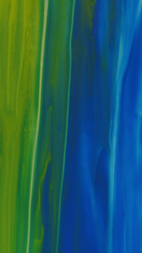Green and blue paint texture in a vertical video.