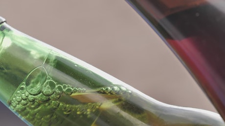Green glass bottle of beer detail view.