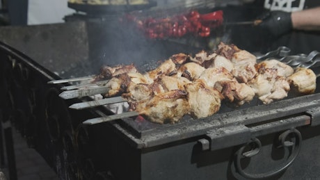 Grill with meat skewers