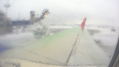 Ground crew spraying an aircraft.