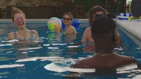 Group of diverse friends in the pool.