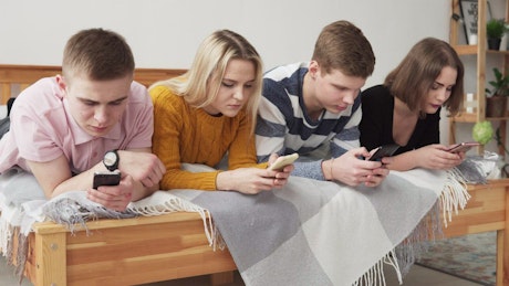 Group of friends glued to their phones.