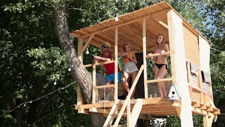 Group of friends in a treehouse.