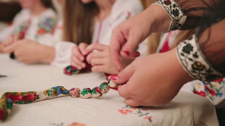 Group of girls making handmade jewelry.