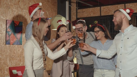 Group of people in the office toasts to the Christmas season.