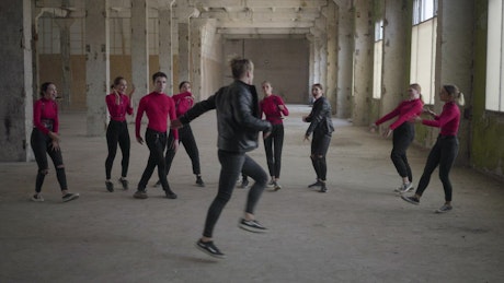 Group of young hip hop dancers perform in old building