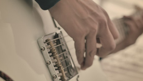 Guitar being played by hands with painted nails