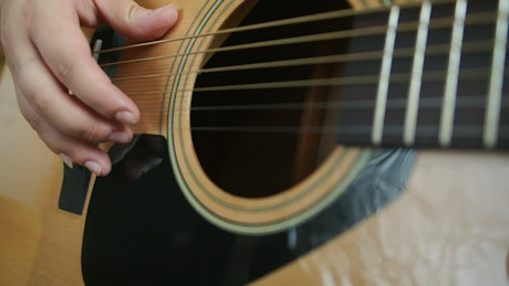 Guitarist playing an acoustic guitar.