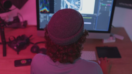 Guy working editing a video on the computer.