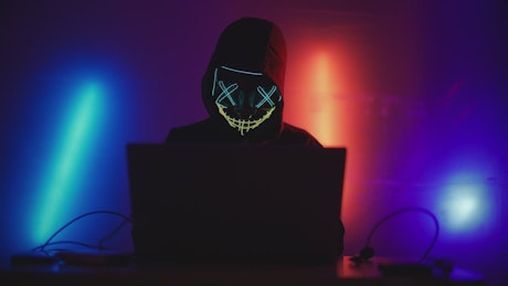 Hacker working on a laptop.