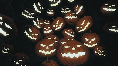 Halloween pumpkins falling in the dark.