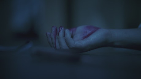 Hand of a body at a crime scene