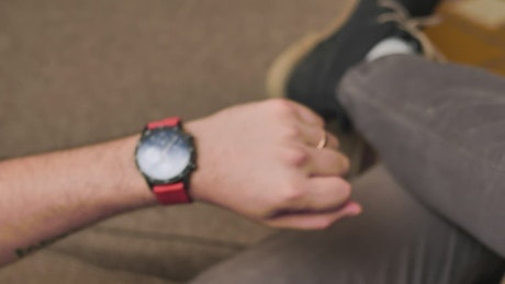 Hand of a man looking at his smart watch.