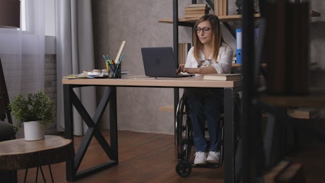 Handicapped woman working from home.