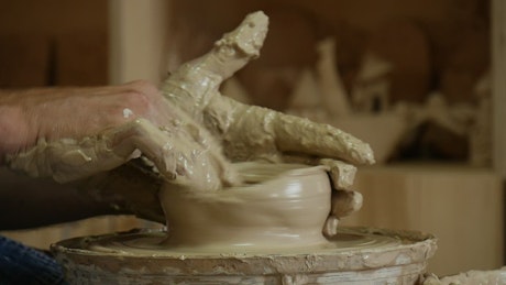 Hands full of ceramic clay
