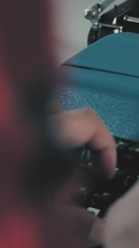 Hands of a person typing on a typewriter