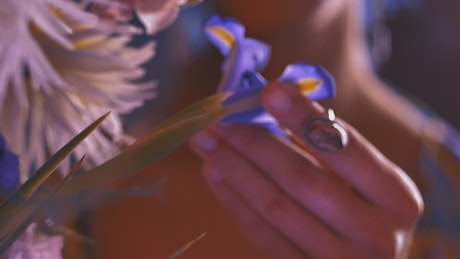 Hands of an LGBTQ man playing with a flower