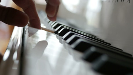 Hands playing the piano.