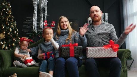 Happy family with Christmas gifts at home