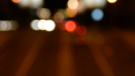 Headlights out of focus against the night