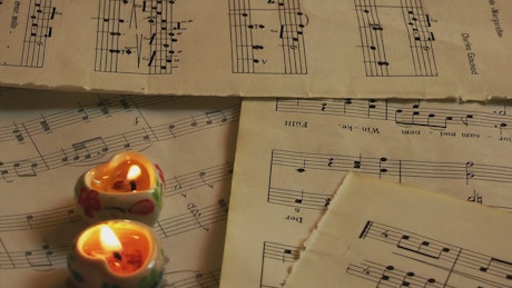 Heart candles on sheet music.