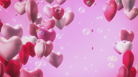 Hearts and bubbles floating on pink background.