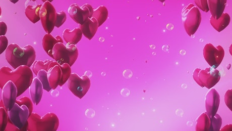 Hearts and bubbles on pink background.