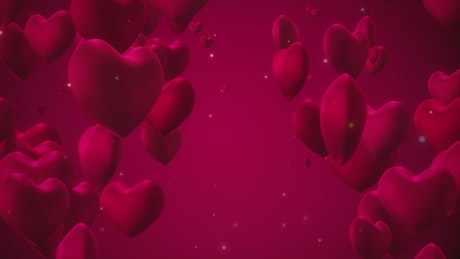 Hearts floating on red background.