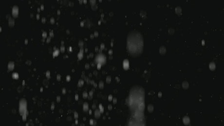Heavy snow falling on a dark background