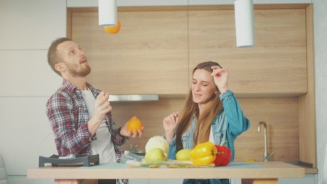 Hilarious couple having fun in the kitchen.