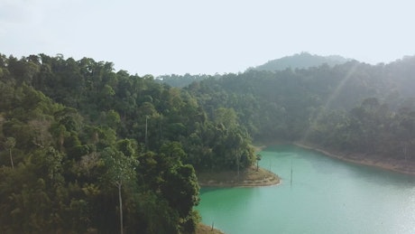 Hills with trees on a turquoise lake
