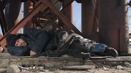Homeless man sleeping outdoors