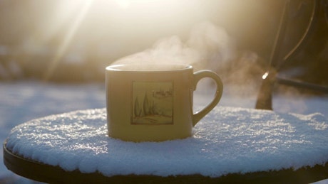 Hot beverage and steam outdoors.